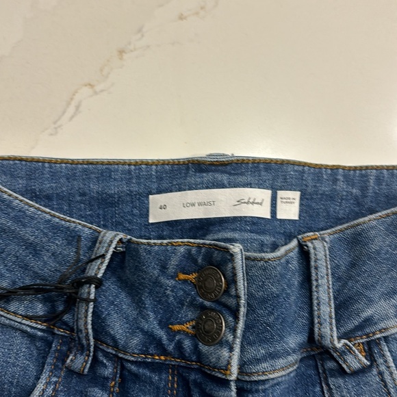 Subdued Low Waist Flare Jean With Front Square Pockets - Picture 8 of 13